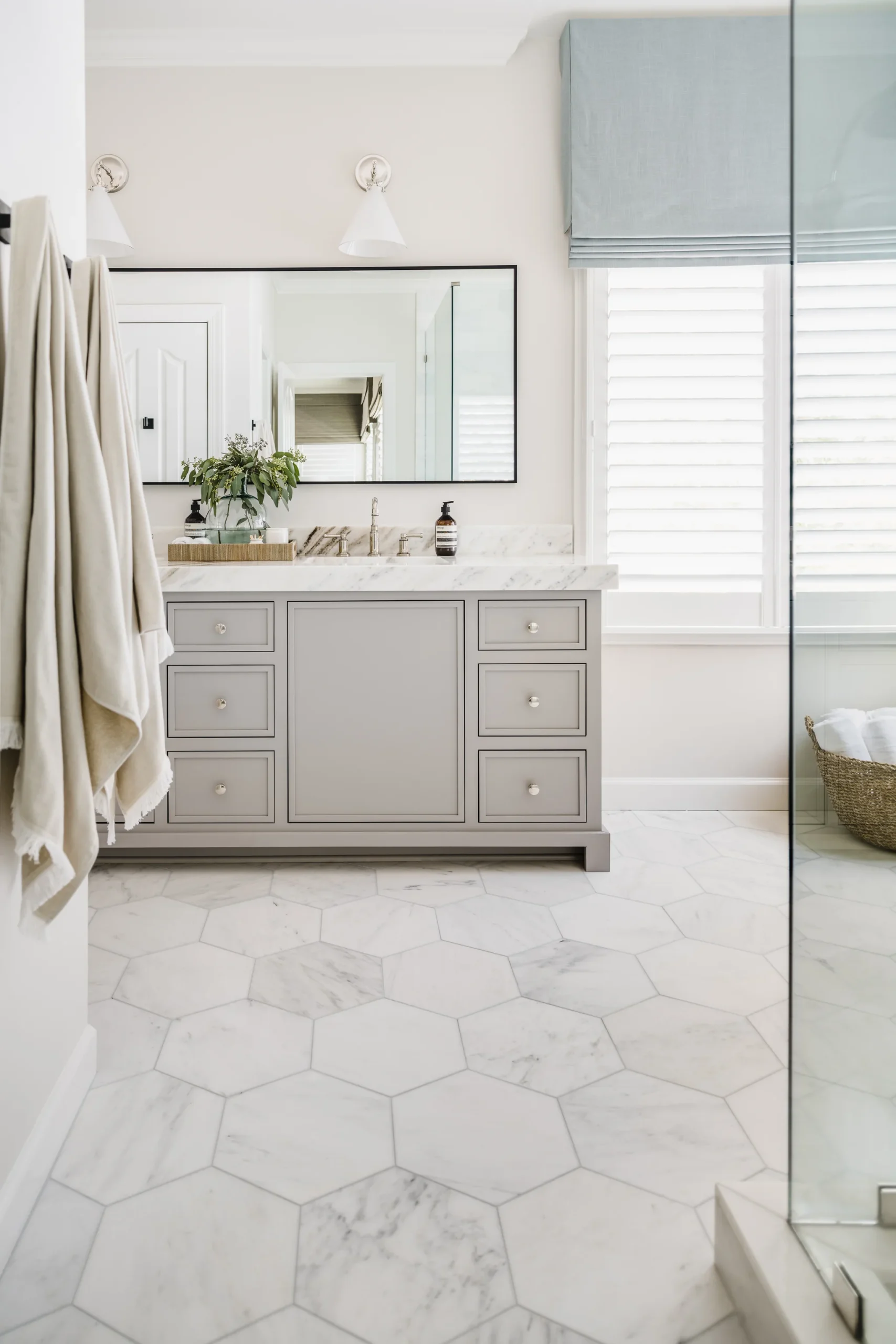 Bathroom remodel in Providence Plantation with a gray vanity, marble countertop, and hexagon floor tiles