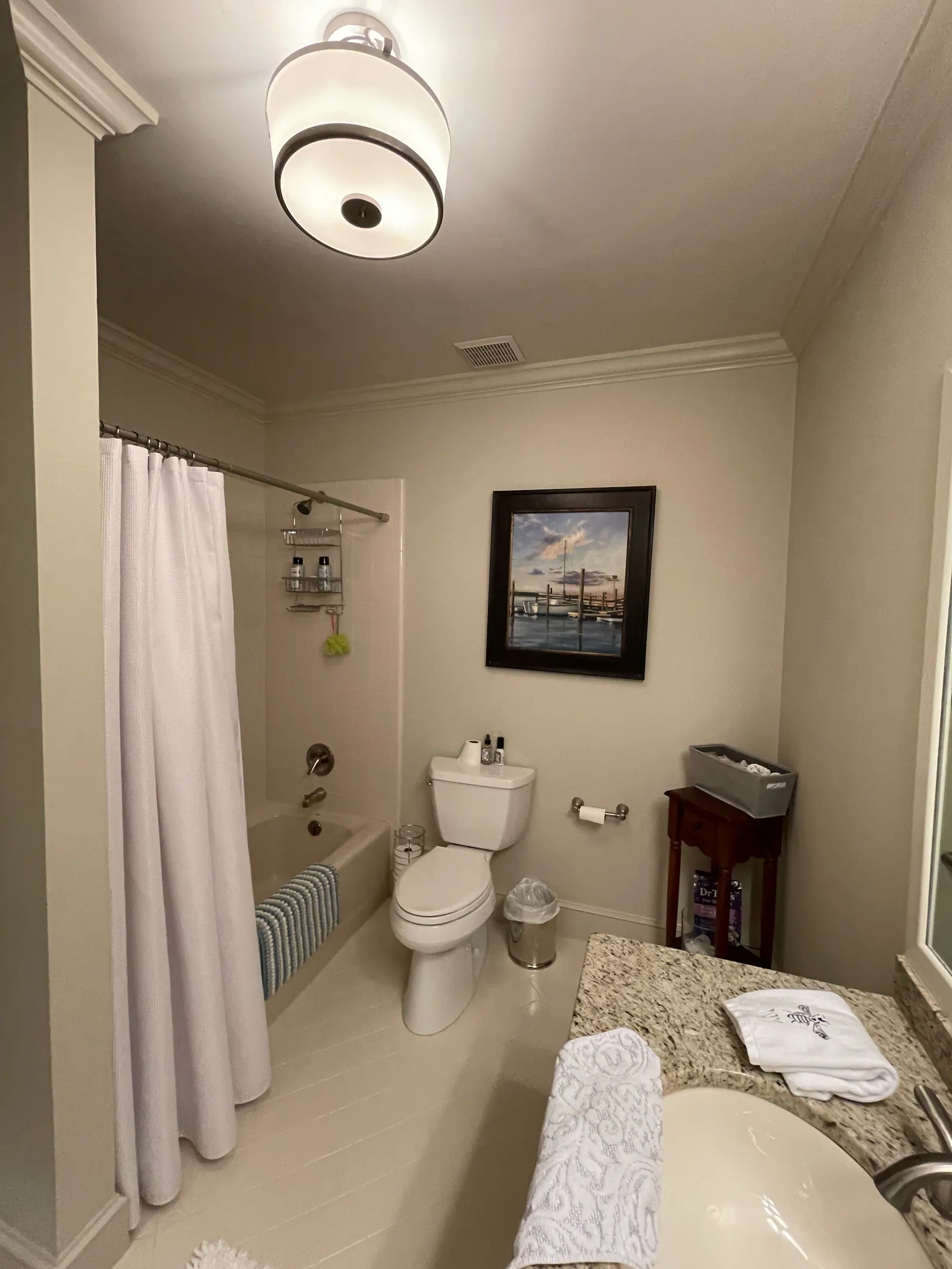 Bathroom remodel in Quail Hollow with a tub-shower combo, toilet, and granite vanity