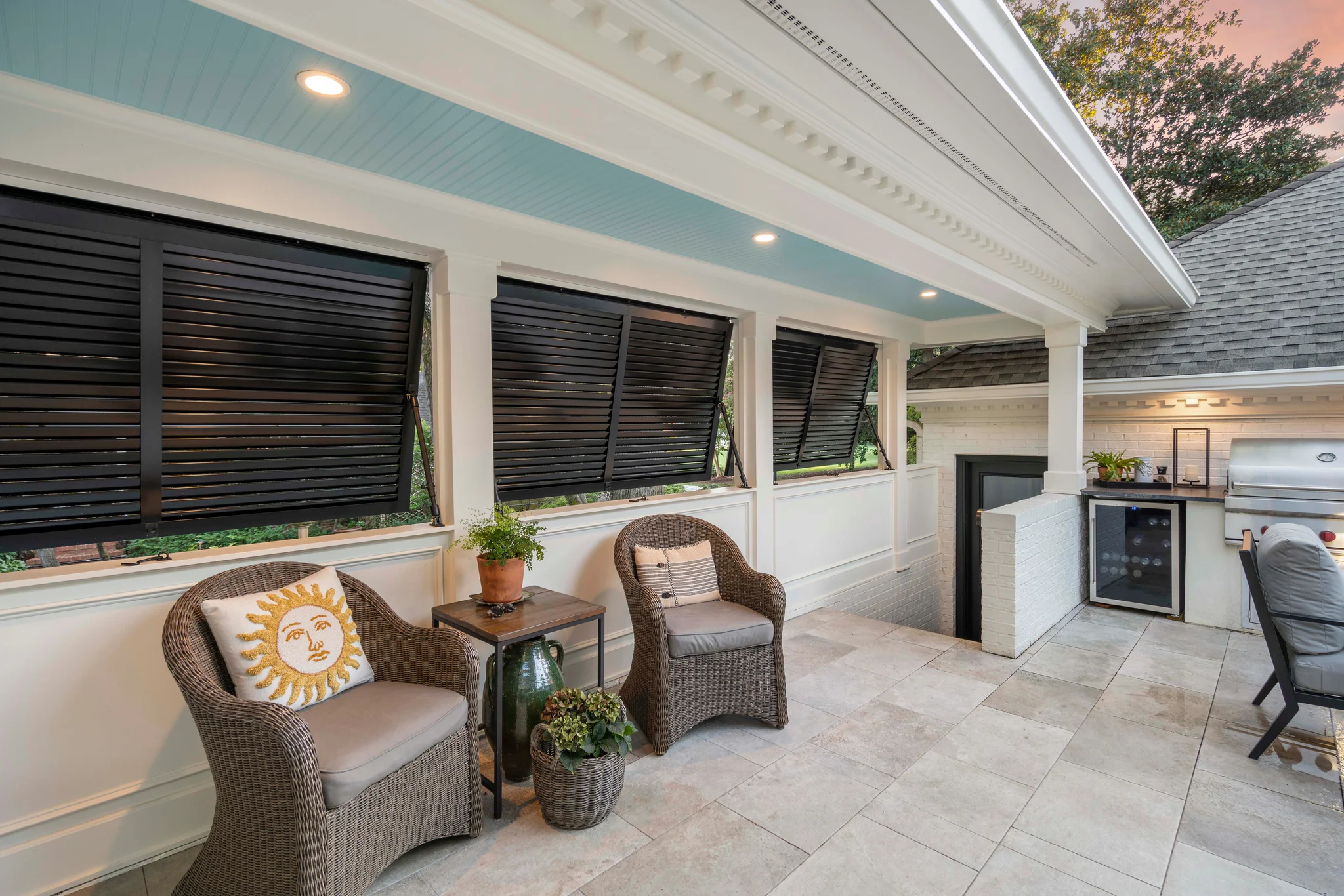 Outdoor renovation in Morrocroft with black louvered shutters, light blue ceiling, and outdoor kitchen