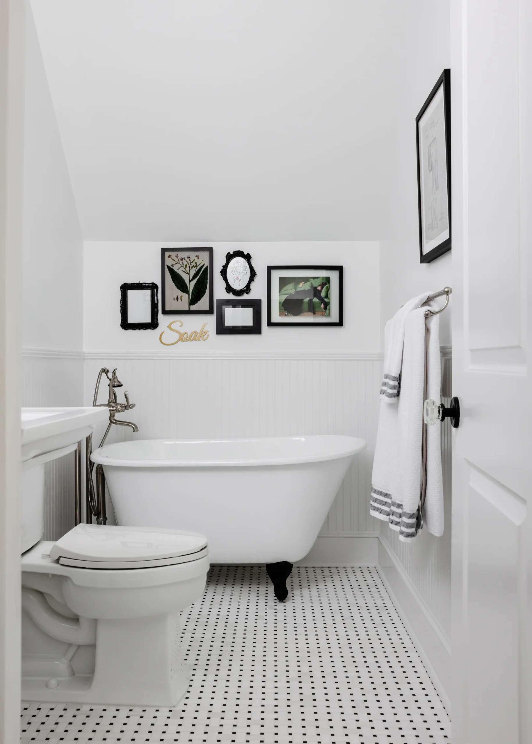 After: White Quail Hollow bathroom with a clawfoot tub, beadboard, and a gallery wall