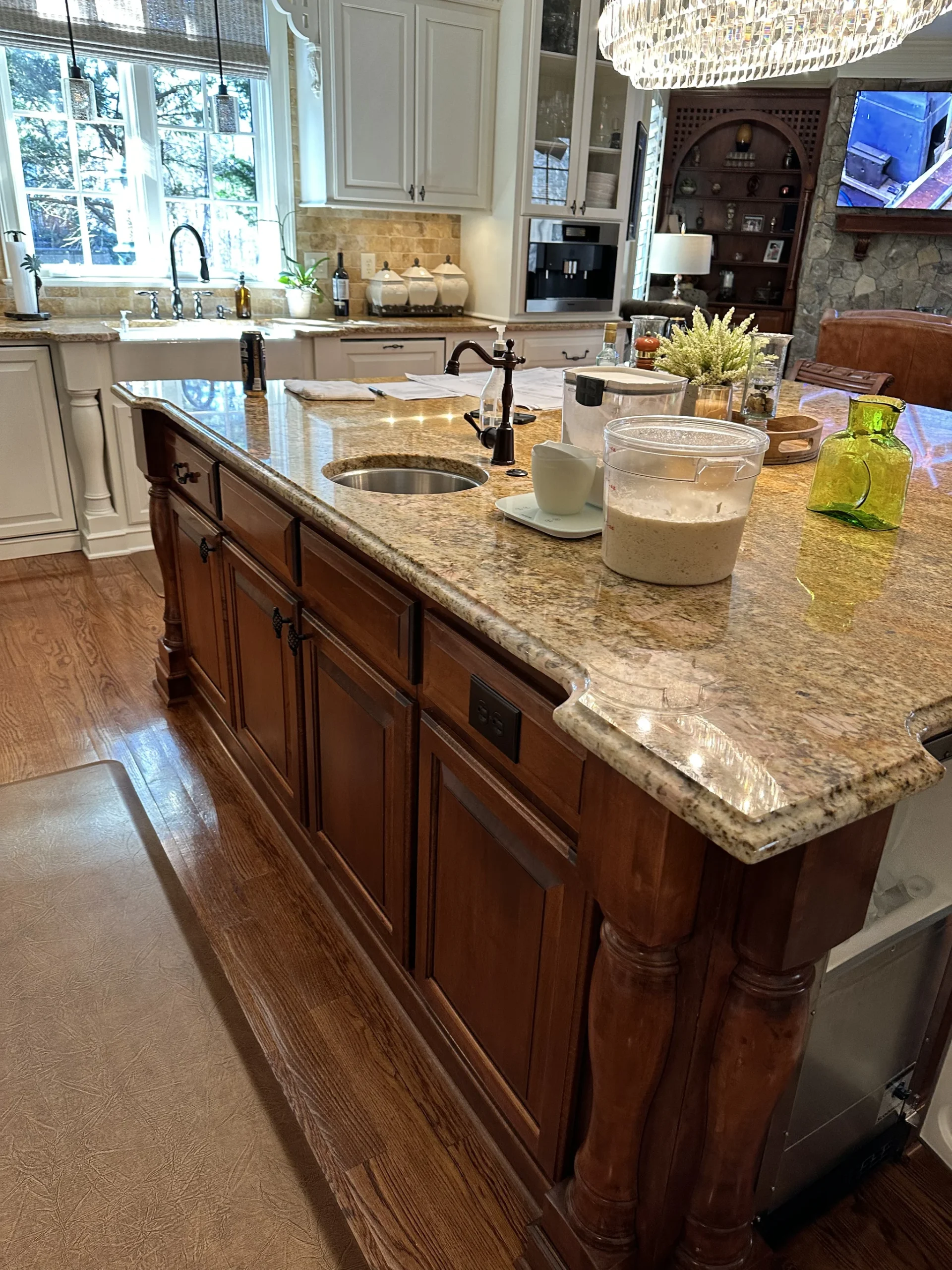 Kitchen remodel in Longview Country Club with a granite island, wood cabinets, and a farmhouse sink