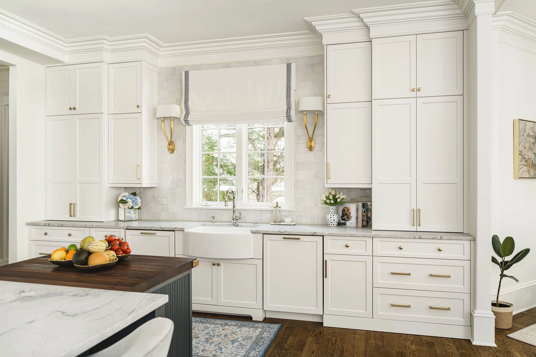 Kitchen remodel in Longview Country Club with white cabinets, marble counters, and a farmhouse sink