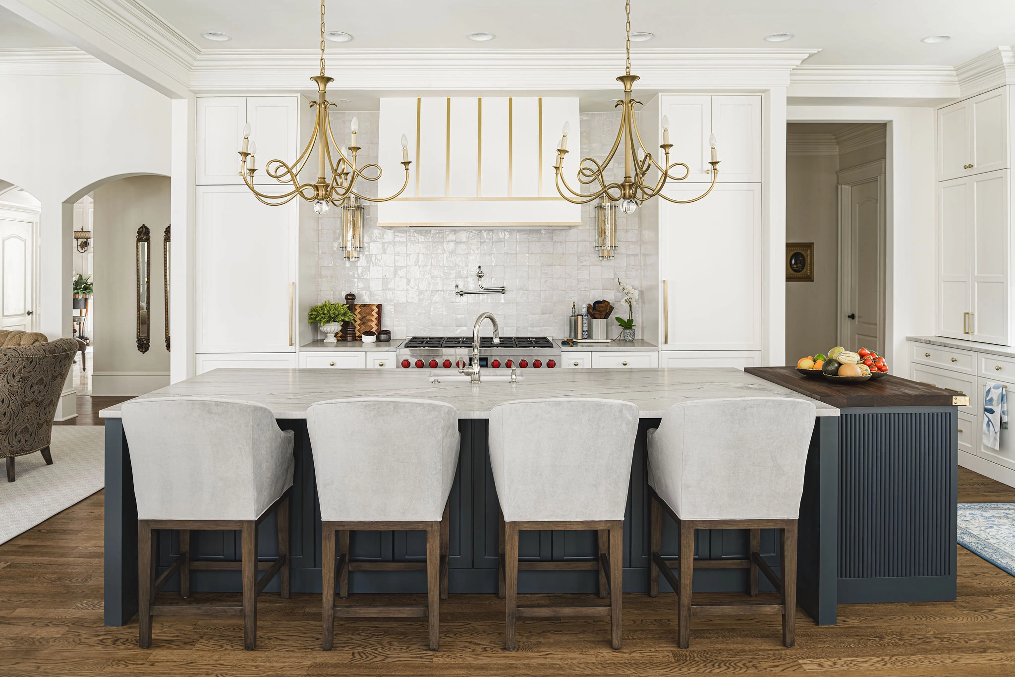 Kitchen remodel in Longview Country Club with white cabinets, dark island, and gold chandeliers