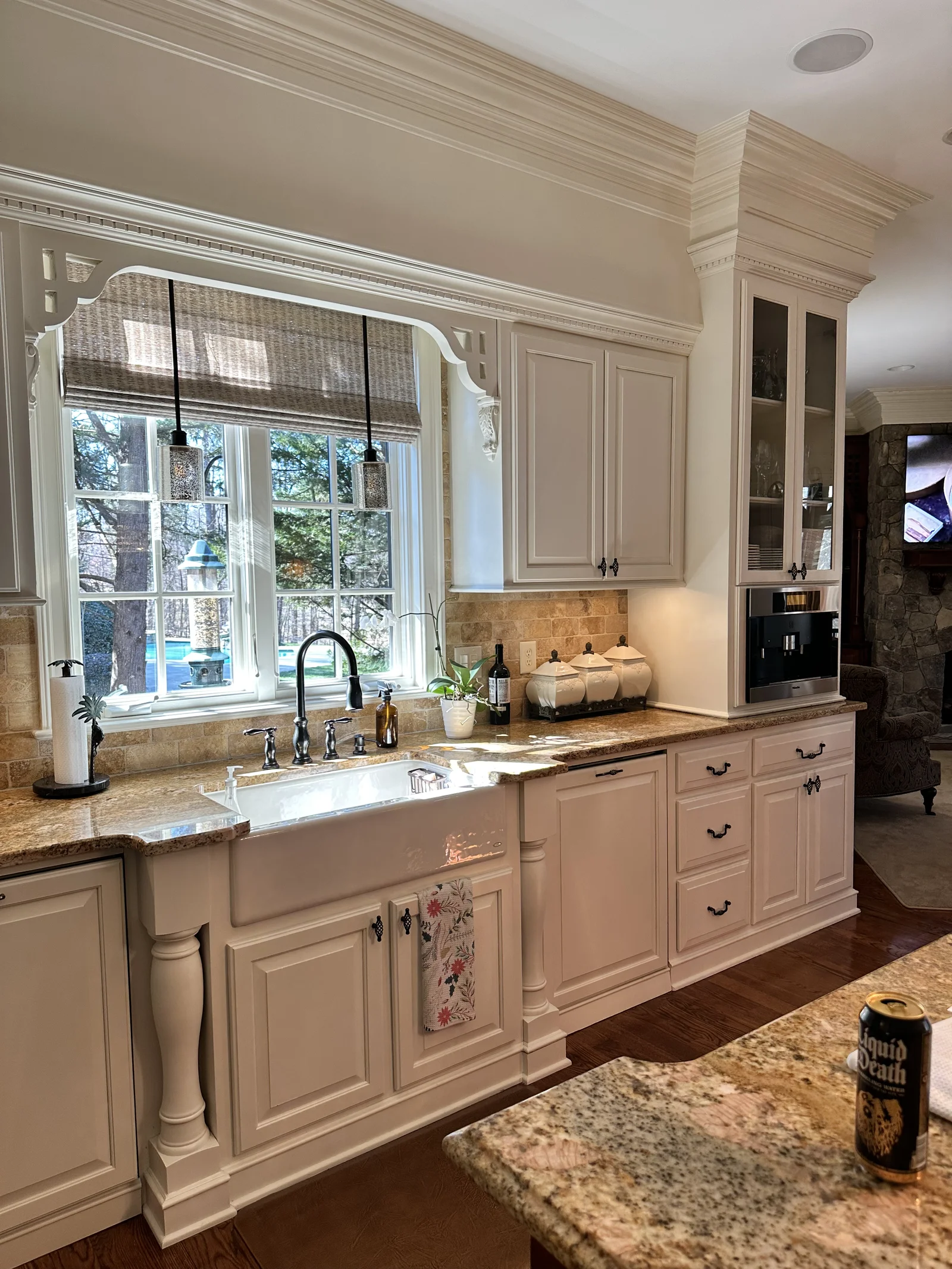 Kitchen remodel in Longview Country Club with white cabinets, granite counters, and a farmhouse sink