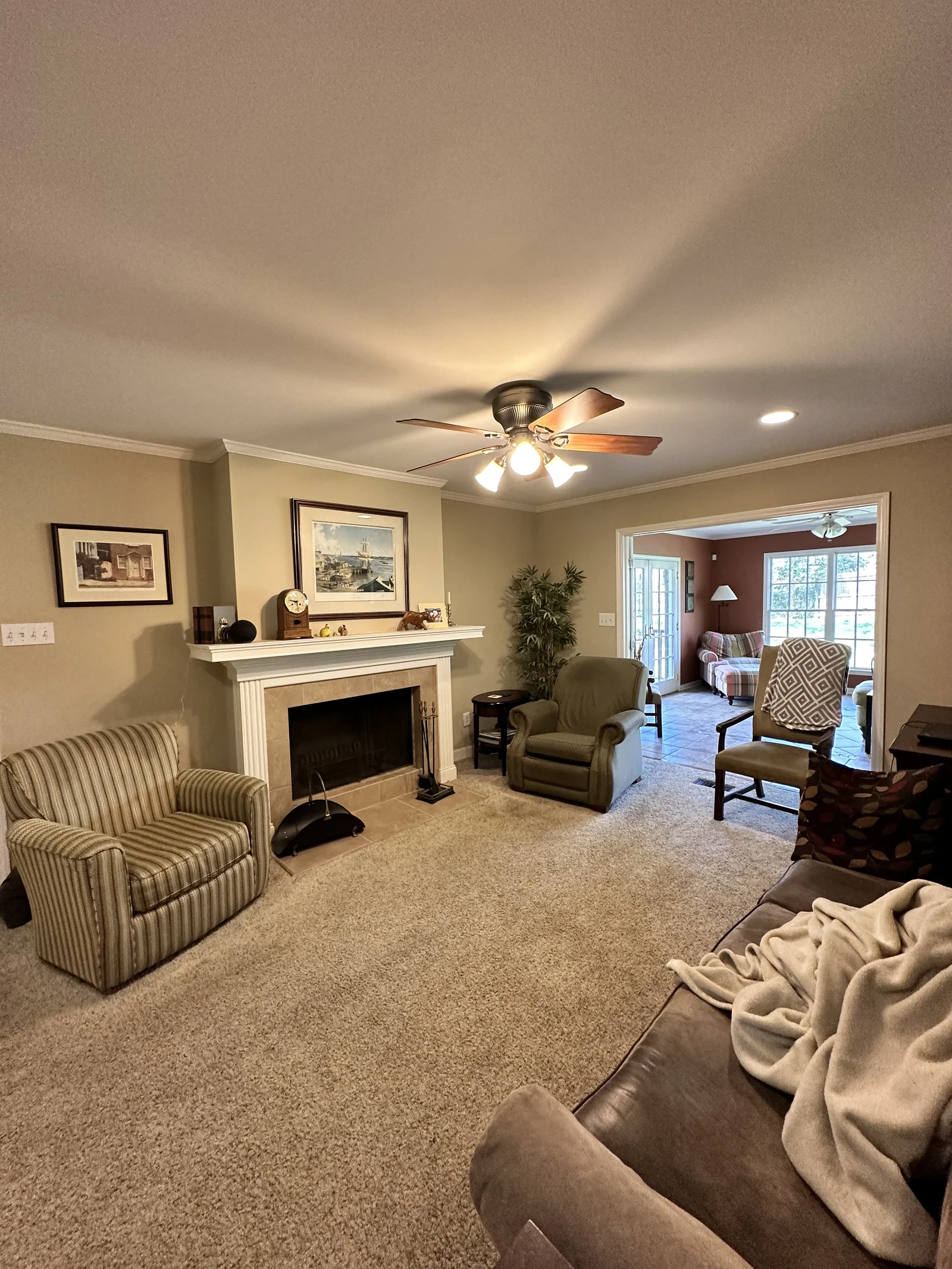 First-floor remodel in Old Georgetown, living room with fireplace, ceiling fan, and carpet flooring