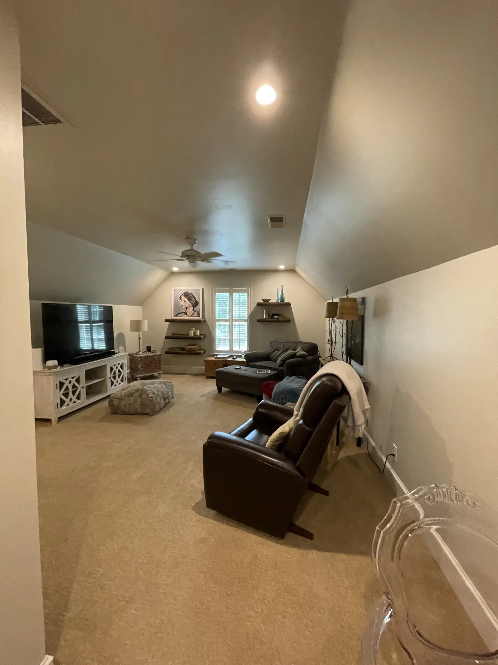 Before: Finished attic living room in Quail Hollow with a sloped ceiling, recessed lights, and carpet