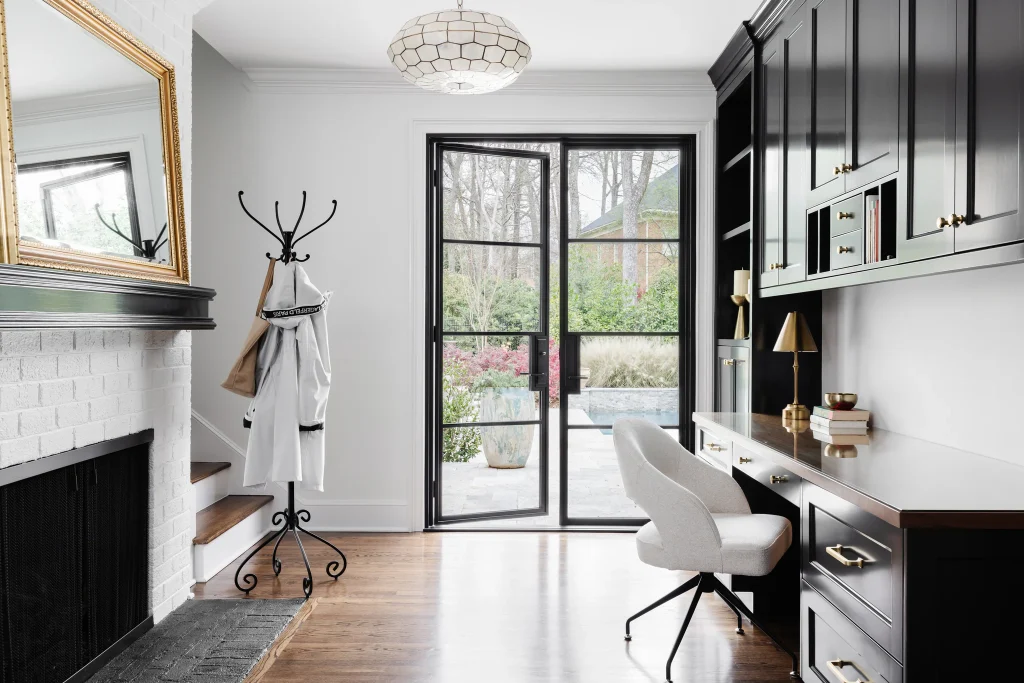 Whole-home remodel in Quail Hollow, home office with black cabinets, white desk, and French doors to patio