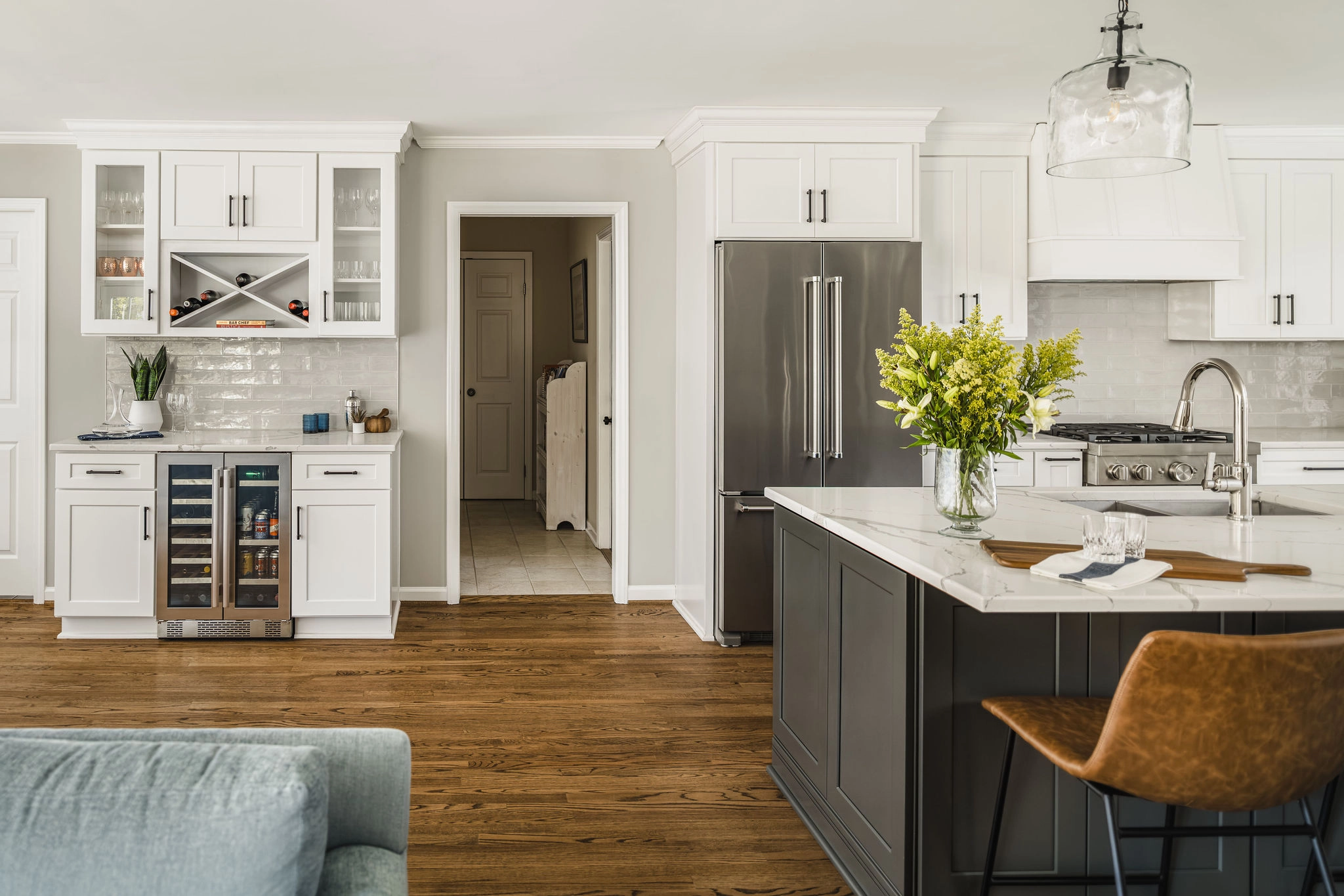 After: Old Georgetown kitchen with white shaker cabinets, a dark gray island, and hardwood floors
