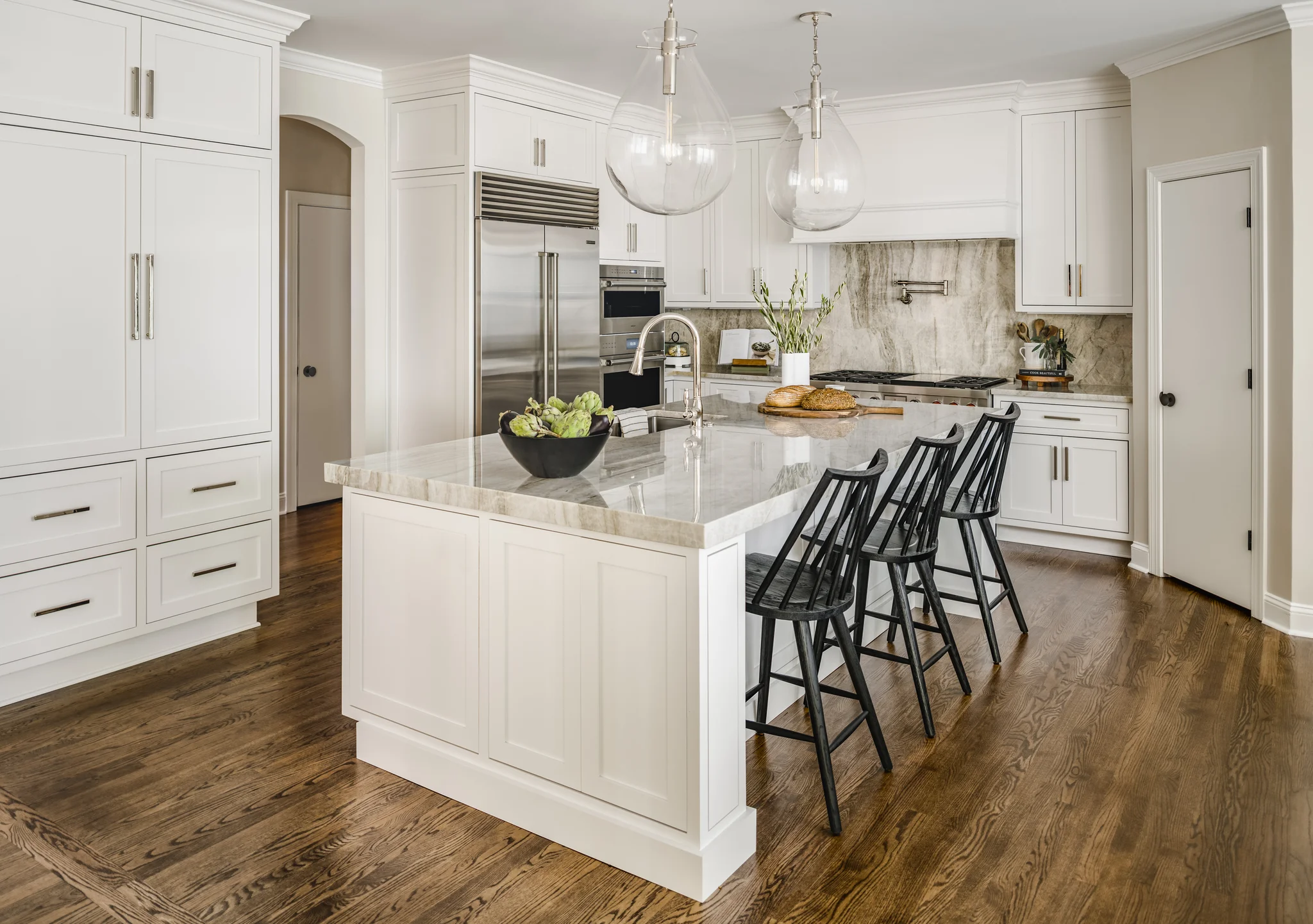 After: Providence Plantation kitchen with white cabinets, a large island, and wood floors
