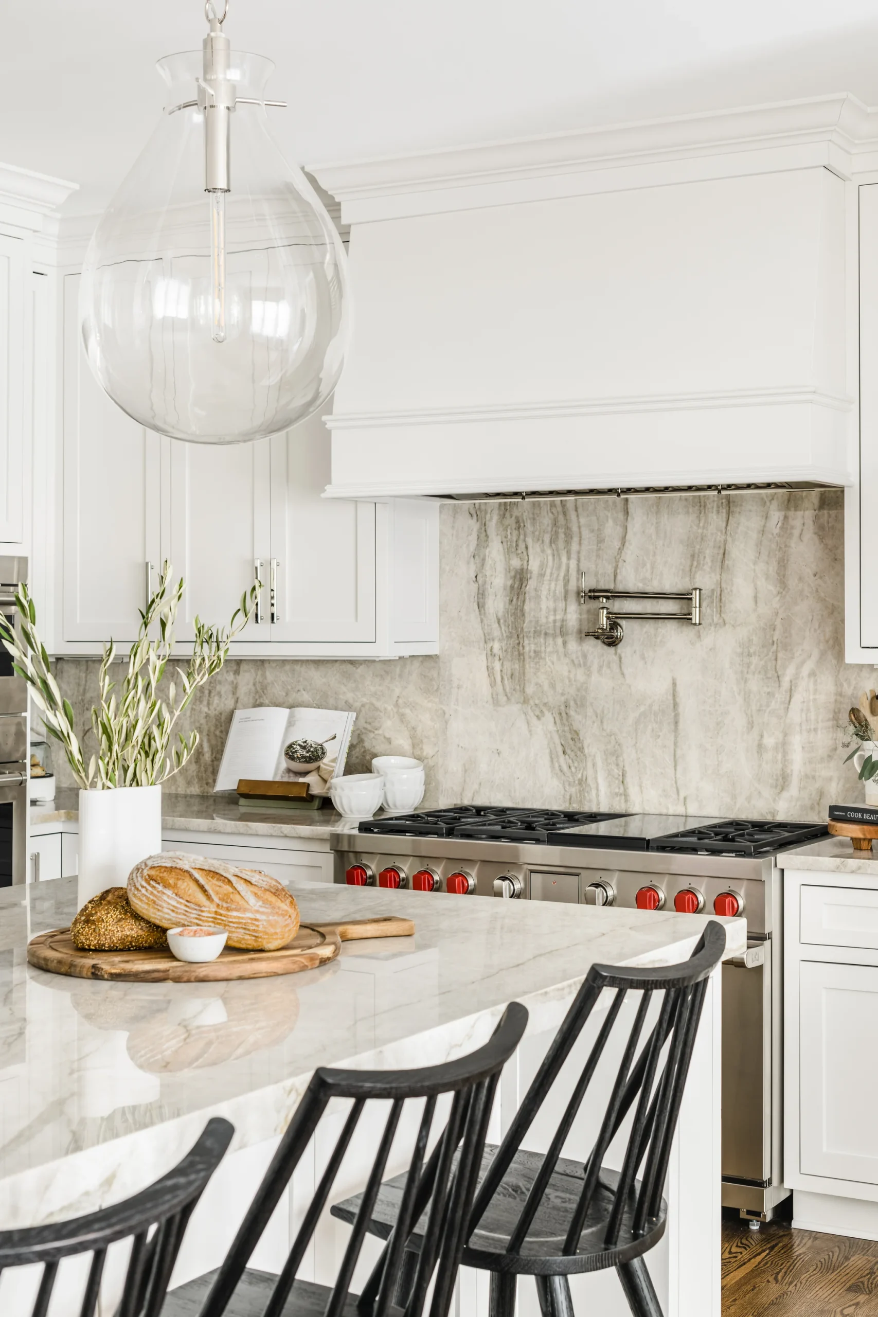 Kitchen remodel in Providence Plantation with white cabinets, marble backsplash, and island seating