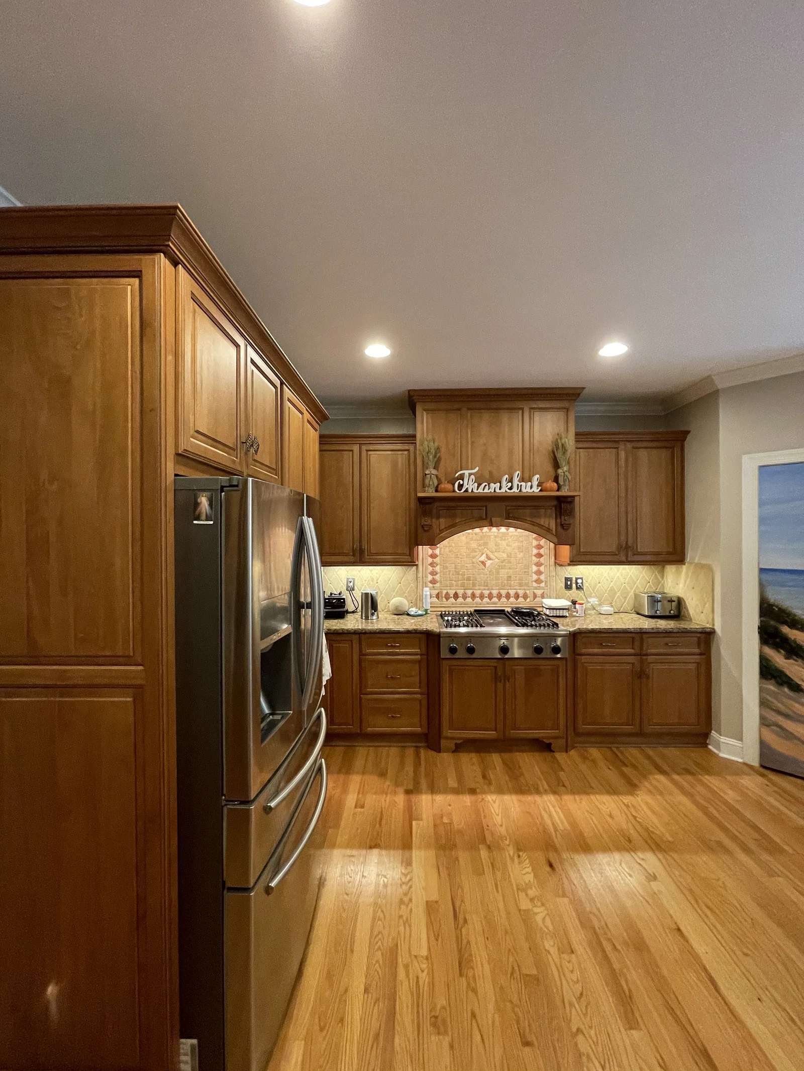 Kitchen remodel in Providence Plantation with wood cabinets, stainless steel appliances, and hardwood floors