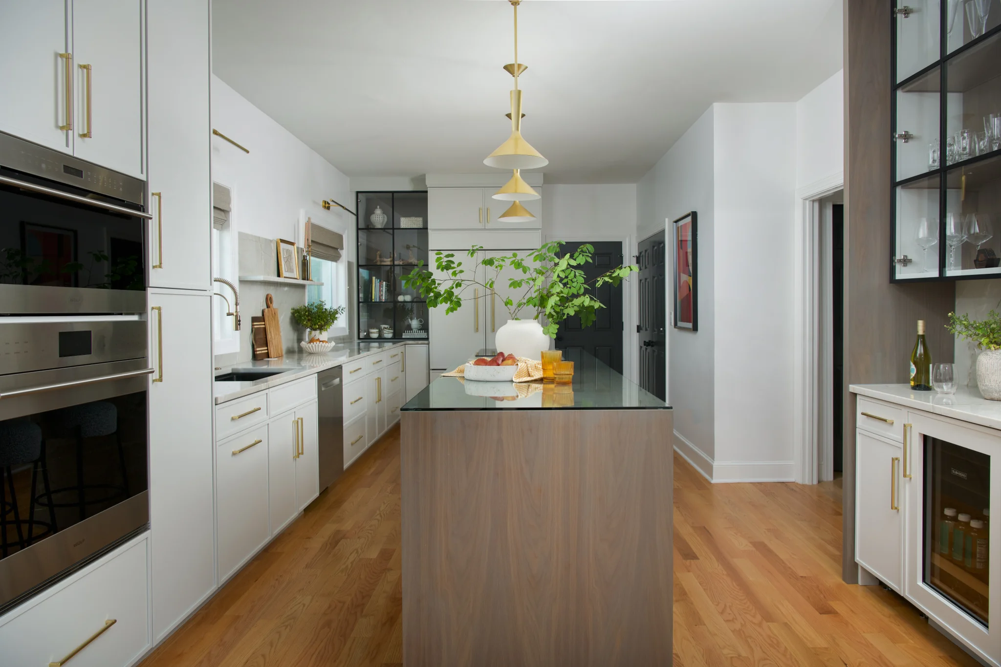 Kitchen remodel in Charlotte, NC, with white cabinets, a wood island, and stainless steel appliances