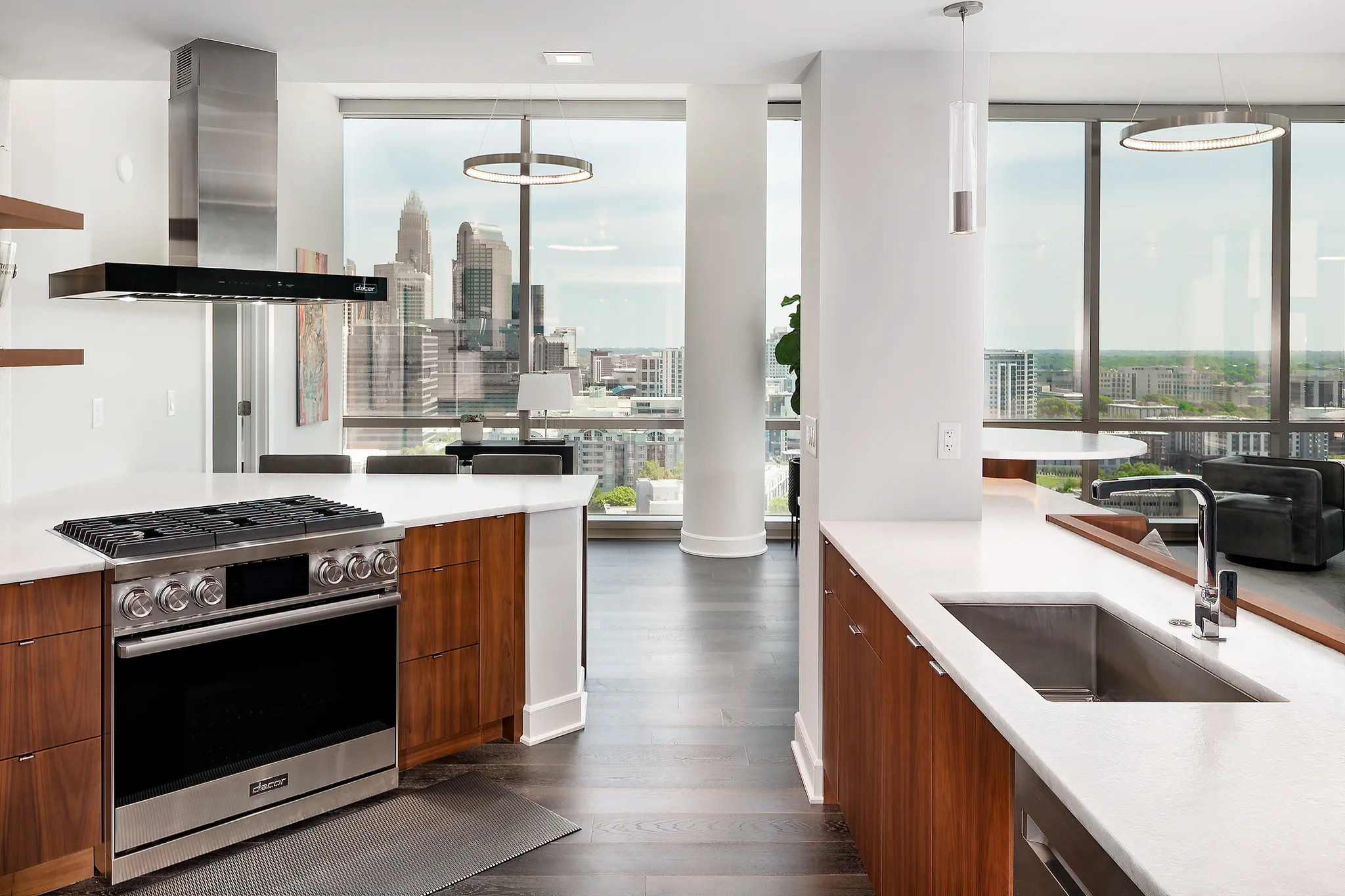 Penthouse kitchen remodel at The Arlington, Charlotte, with city views, white countertops, and wood cabinets