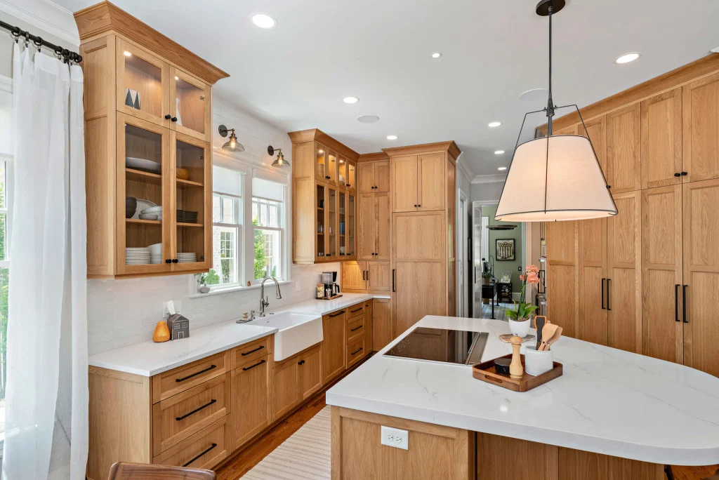 Kitchen remodel in Heydon Hall with light oak cabinets, white quartz countertops, and a large island