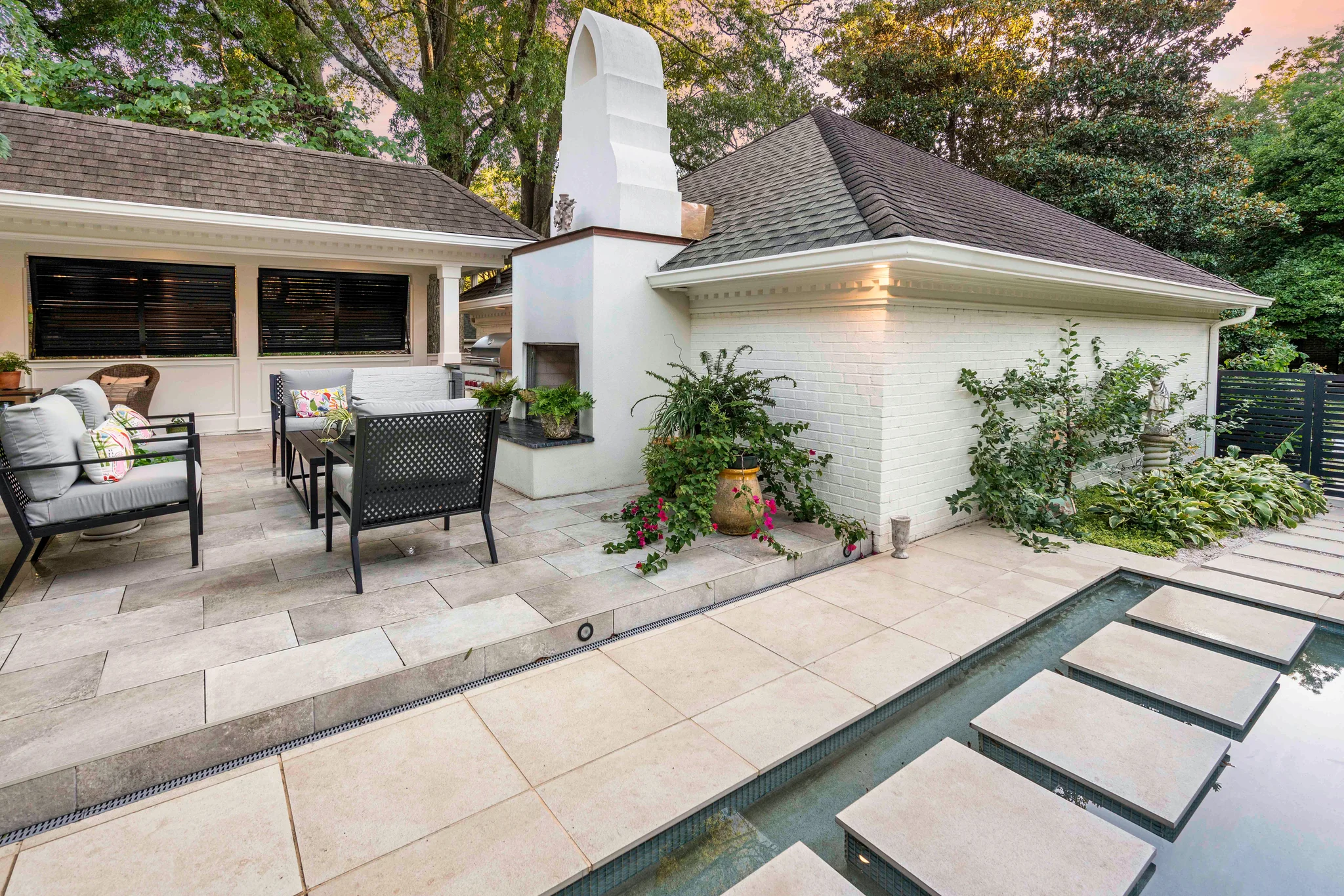 Outdoor renovation in Morrocroft with a patio, fireplace, and stepping stones over a shallow pool