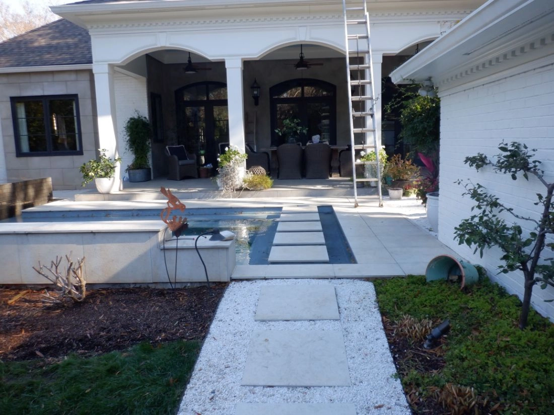 Before: Morrocroft backyard with a patio, a pool, and a covered porch with seating