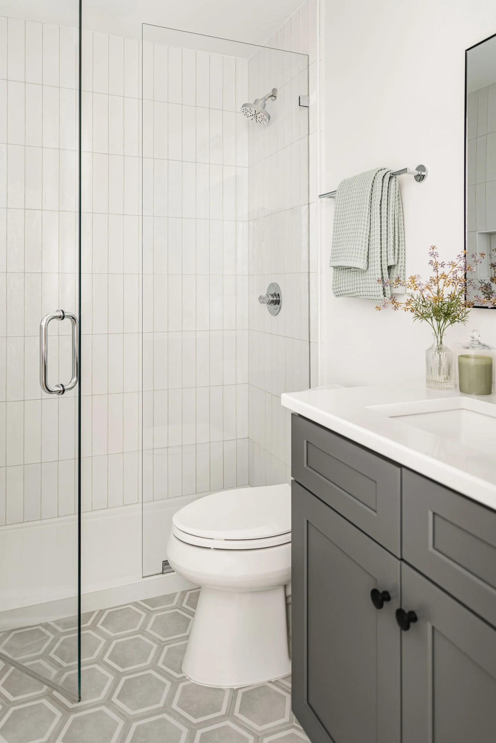 Bathroom remodel in Old Georgetown with a walk-in shower, vertical white tile, and a gray vanity