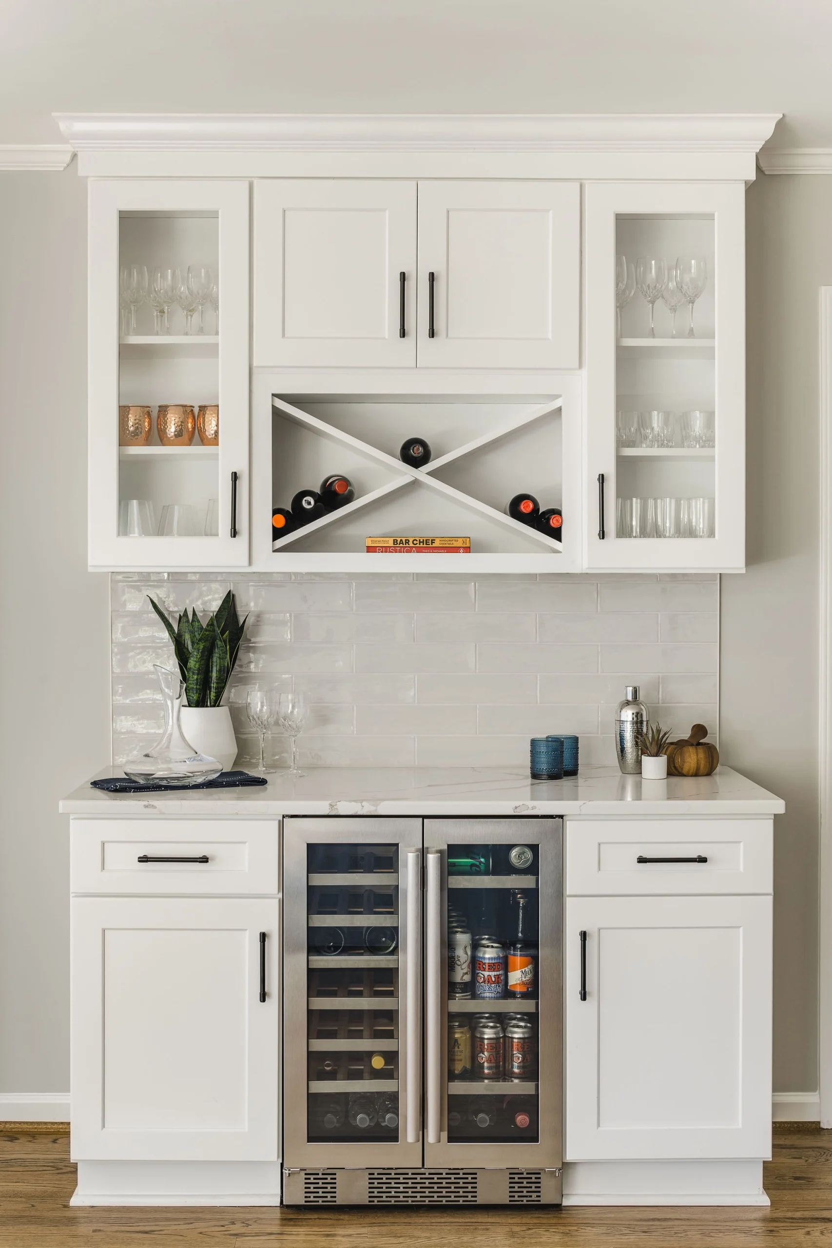 Wet bar in Old Georgetown with white shaker cabinets, quartz counters, and a dual-zone beverage fridge