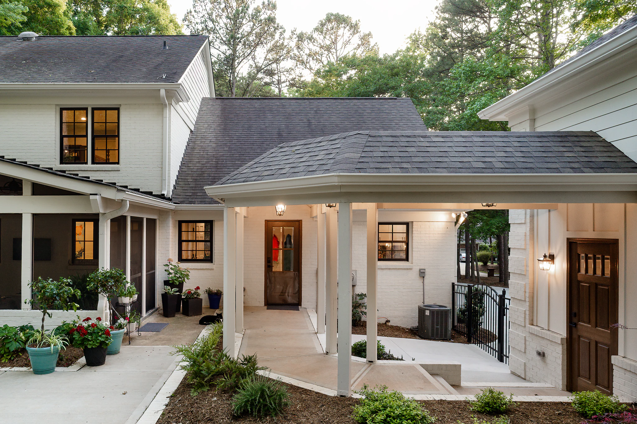 Whole-home remodel in Providence Plantation, white brick exterior, covered patio, dark roof shingles