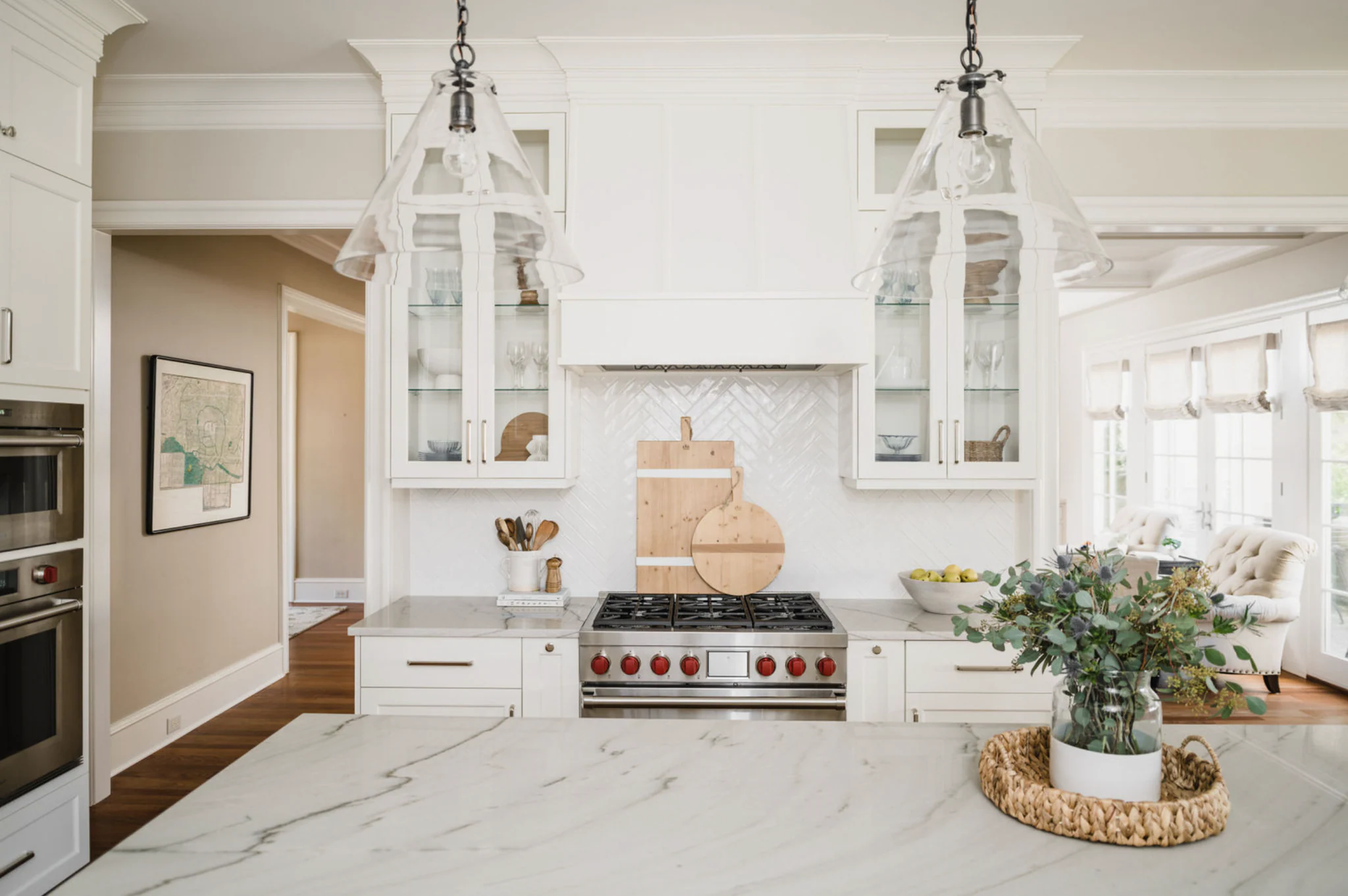 Whole-home remodel in Ballantyne Country Club, white kitchen with herringbone backsplash, pendant lights