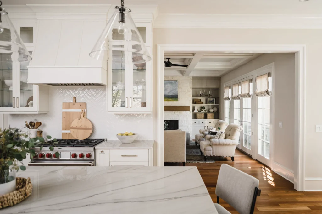 Ballantyne Country Club whole-home remodel, white kitchen with herringbone backsplash, view of living room