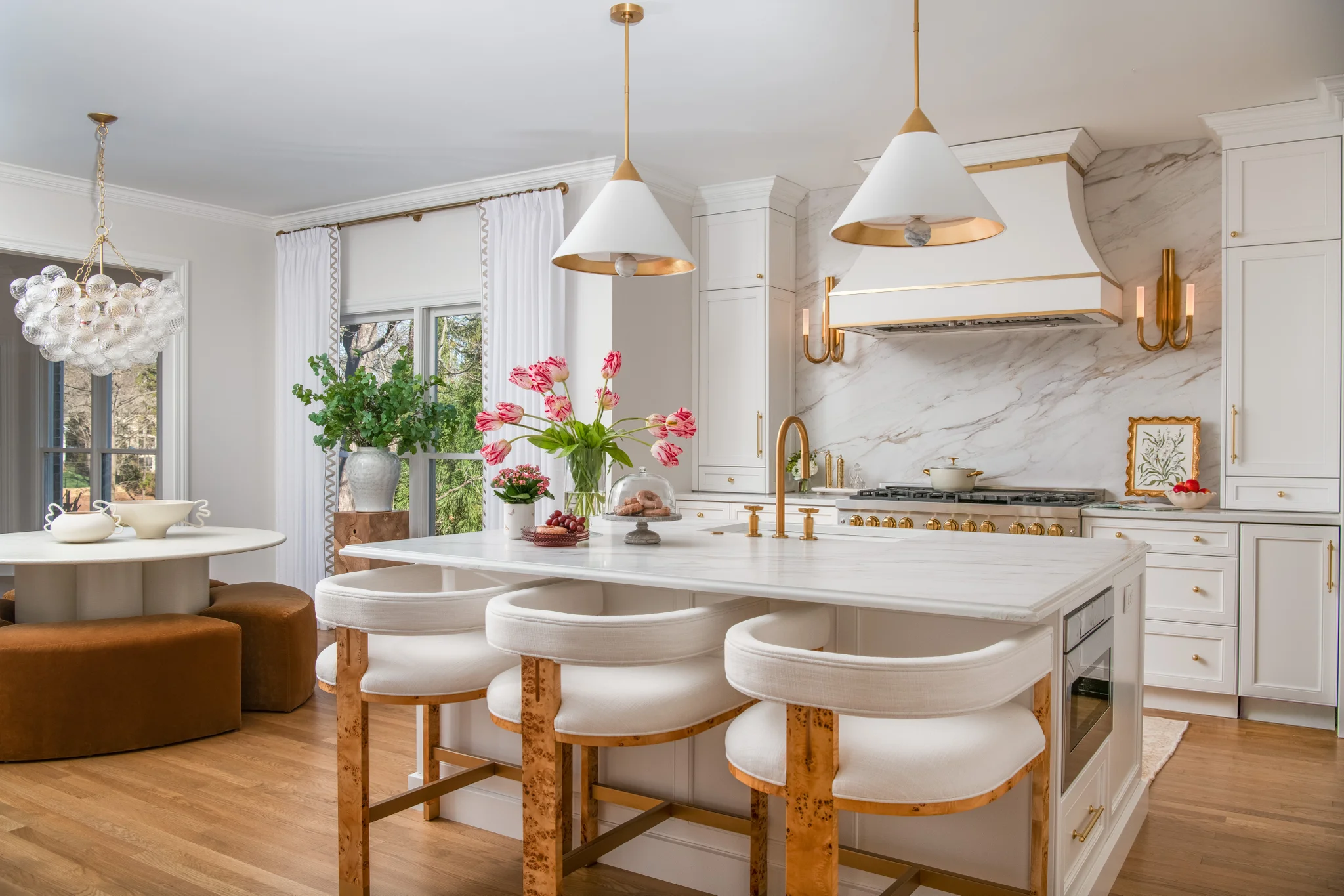 After: Ballantyne Country Club kitchen with white cabinets, a marble backsplash, and gold accents