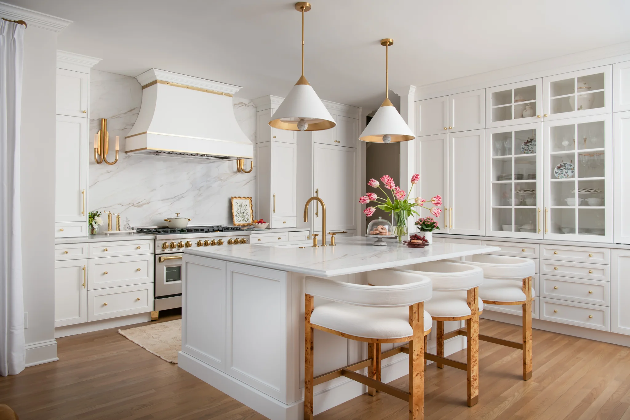 Kitchen remodel in Ballantyne Country Club with white cabinets, marble backsplash, and gold accents
