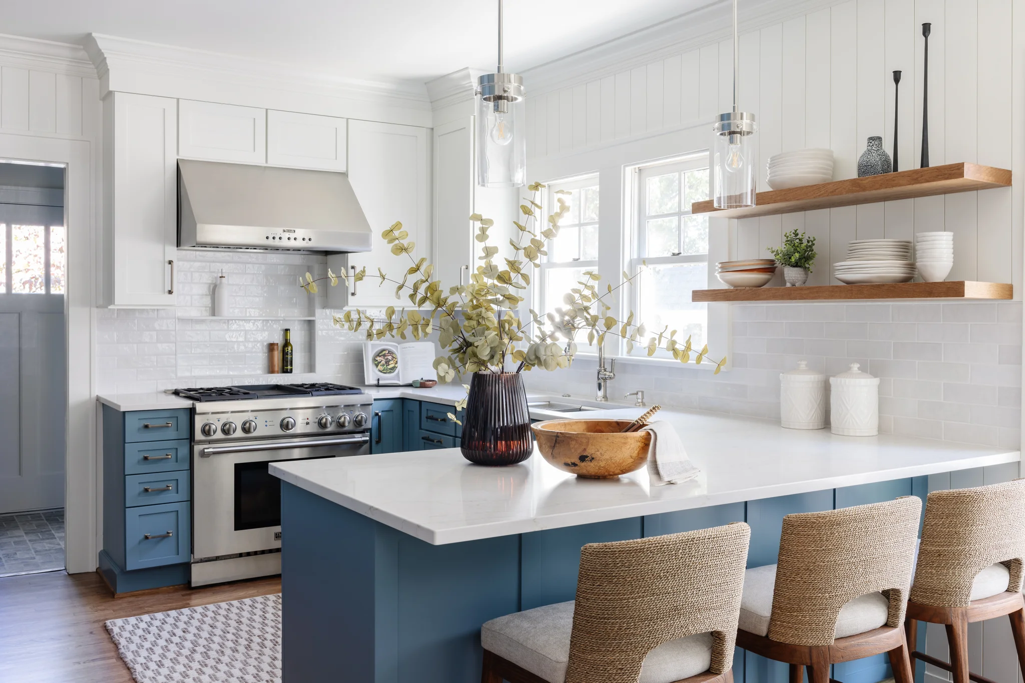 Whole-home remodel in Historic Dilworth, kitchen with blue island, white cabinets, and wood shelves