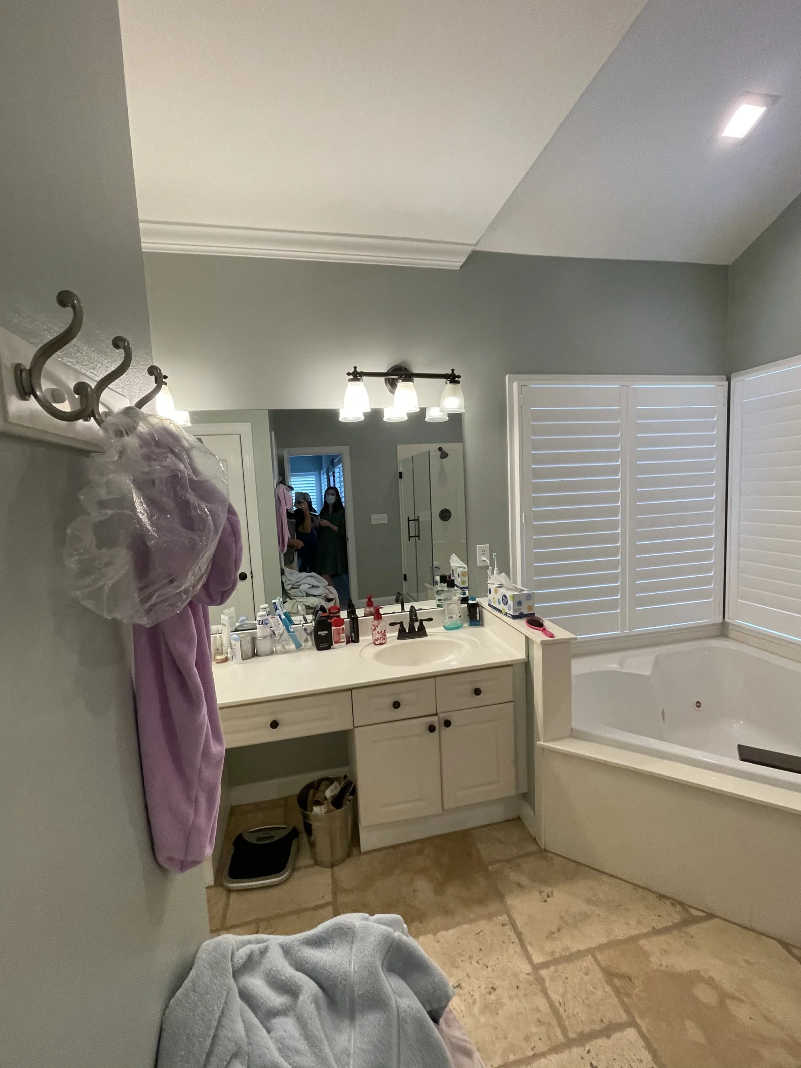 Whole-home remodel in Providence Plantation, bathroom with light gray walls, white vanity, and tub