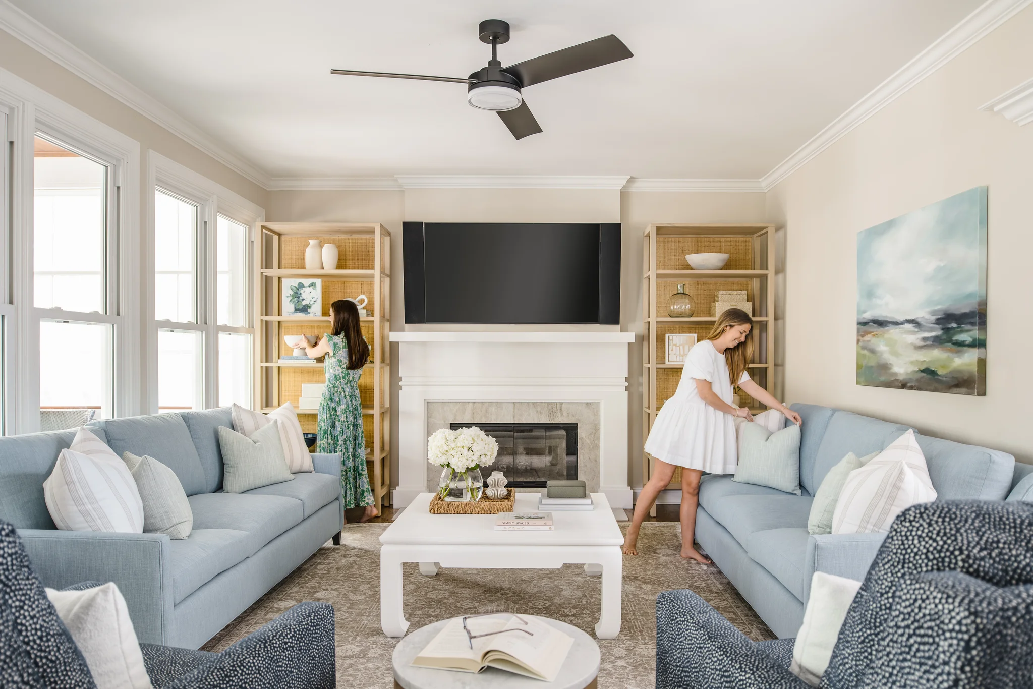 Whole-home remodel in Providence Plantation, living room with light blue sofas, a white coffee table, and built-in shelves beside the fireplace