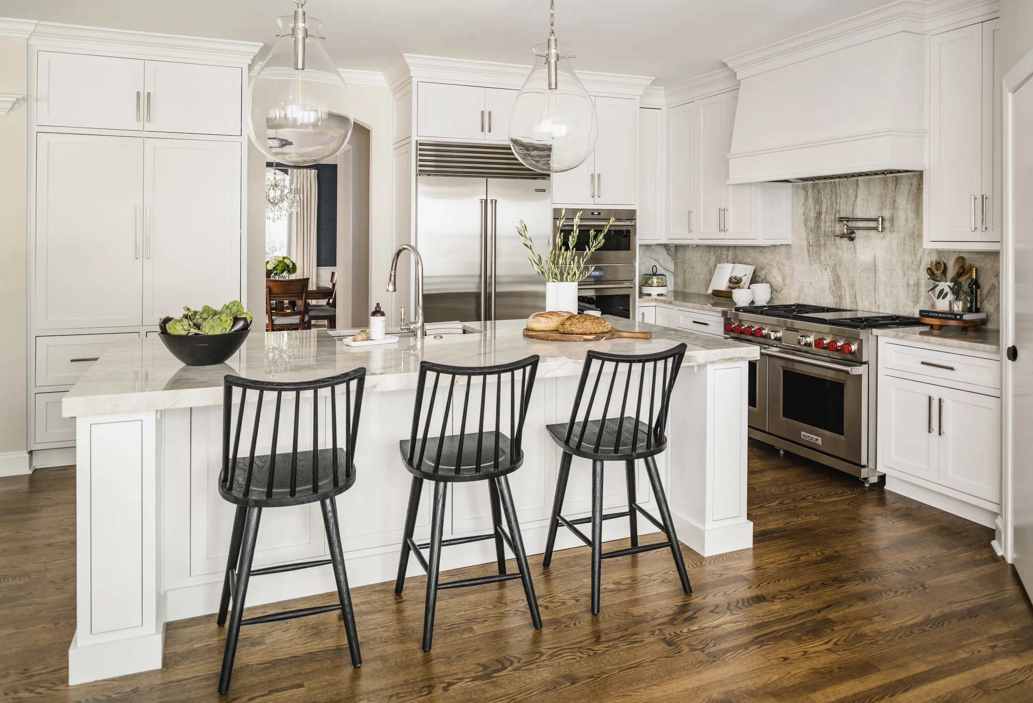 Whole-home remodel in Providence Plantation with a white kitchen, large island, and wood floor